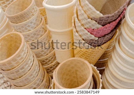 Lots of stacked empty ice cream cones, close up shot, abstract food background