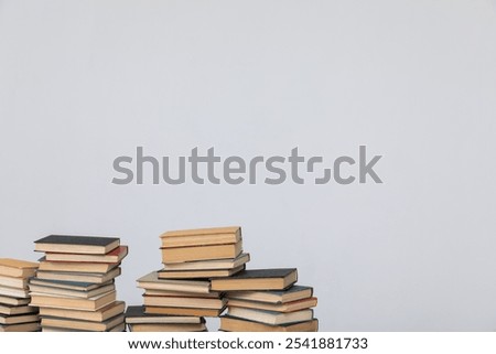 lots of stacks of books to study in the library on a gray background
