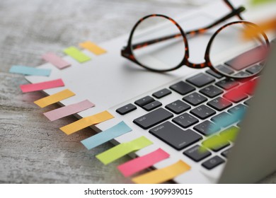 Lots of sticky notes on laptops and a lot of work 