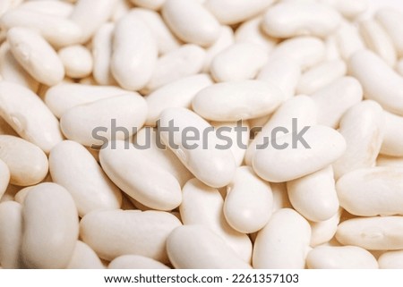 Lots of white beans. Texture background. Top view.