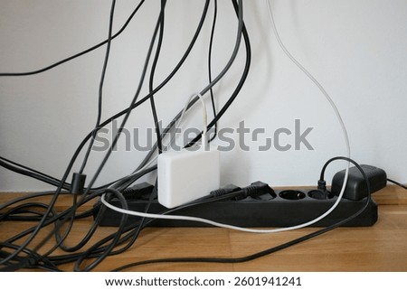 Lots of wires in a socket at work. Cabling chaos. Concept of the problem of saving space and aesthetics