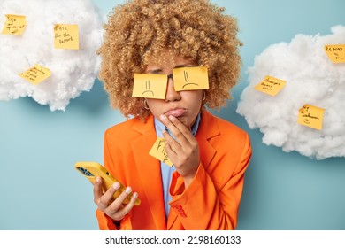 Lots Of Work Concept. Upset Woman Poses With Stickers On Eyes Sad To Get Tiresome Task Has Deadline Dressed In Elegant Formal Clothes Uses Cellphone Wrote Notes About Important Things To Do Today