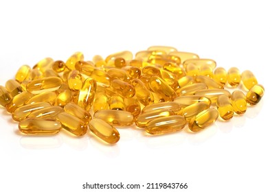 Lots of yellow Omega-3 fish oil capsules isolated on a white background, selective focus - Shutterstock ID 2119843766