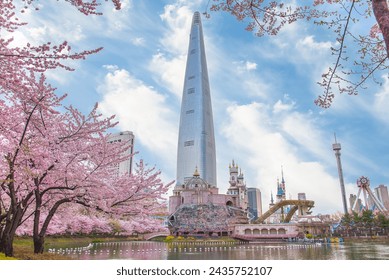 Lotte World Amusement Park and Seokchon Lake  in Spring Cherry blossoms bloom in late March-April.  Seoul, South Korea - Powered by Shutterstock