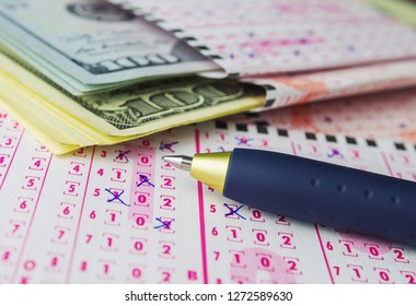 Lottery Tickets With Pen And US Dollars. Conceptual Image Of Gambling, Easy Money. Close-up, Selective Focus.