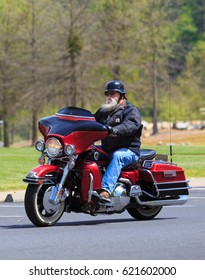 LOTTUS, CALIFORNIA, USA - APR 15, 2017: Older Man With A White Beard Riding His Red Hallie Davison Motorcycle 