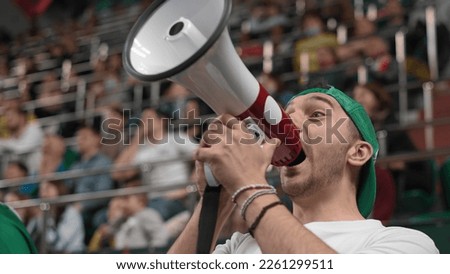 Loud man scream megaphone sport stadium. Crazy mad fan shout bullhorn close up. Insane male cheer team. Furious person yell loudspeaker. Active guy win play goal. Wild crowd watch game cup match arena