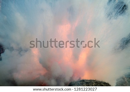 Loud massive explosion of bombs. Blast wave. Huge volumes of black smoke and sparks of fire. Detonation of bomb or cannon ball. Outburst close up. Smoke texture concept. Catastrophic case. 