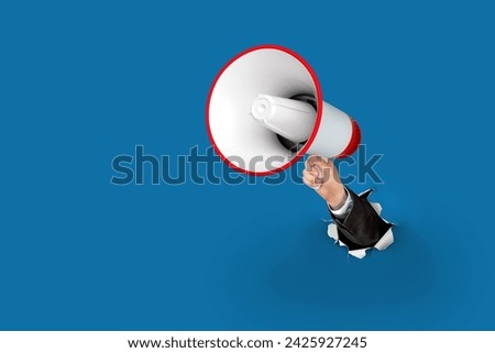 Loudhailer, hand holding megaphone breakthrough paper hole. Announcement, advertising, public hearing concept. Mockup design with loudspeaker, Torn background with blank empty space for copy space.