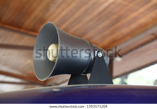 Loudspeaker on the roof of a\
police car.