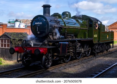 LOUGHBOROUGH, LEICESTERSHIRE, UK - JUNE 3, 2017: Steam locomotive LMS Ivatt Class 2 2-6-0 No. 46521 stands light engine at Loughborough Station during the GCR's 1940’s Wartime Weekend event.