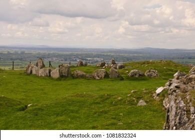Loughcrew Passage Tomb complex of County Meath, Ireland (near Oldcastle). We are looking east, southeast over an arc of curb stones.  Right foreground are curb stones of the primary.