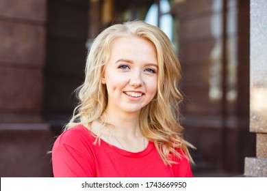 Loughing Beautiful girl walk in the summer Kiev City. Young woman tourist on a street. Street style close up portrait. Stylish girl weared in red casual outfit. Life style. Local tourism. Srteet walk