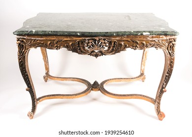 A Louis XV style, green variegated marble-topped serpentine centre table. With carved wood and gilt gesso base with pierced plume and scroll frieze. Supported on acanthus carved cabriole supports join - Shutterstock ID 1939254610
