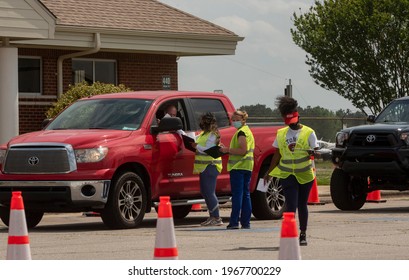 Louisburg, NC- United States- 04-28-2021: Volunteers Staff A Drive Thru Vaccine Clinic For COVID At Triangle North Executive Airport. 