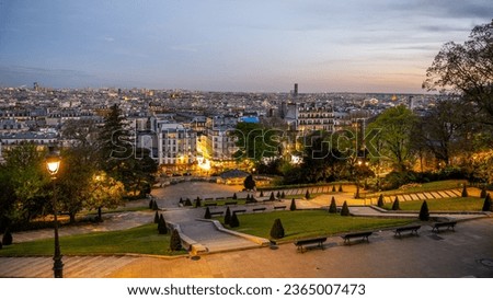 Louise Michel Square at Sacre Coeur in Montmartre and Paris Cityscape by night, France
