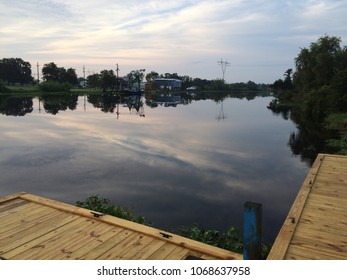 Louisiana Clouds Reflected In The Bayou In The Heart Of Cajun Country.