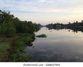 Louisiana Clouds Reflected In The Bayou In The Heart Of Cajun Country.