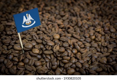 Louisiana Flag Sticking In Roasted Coffee Beans. The Concept Of Export And Import Of Coffee