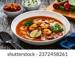 Louisiana soup gumbo with shrimp, chorizo and white rice on wooden table 