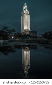Louisiana State Capitol Building At Night Reflecting in a Nearby Water Puddle