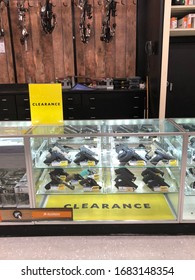 LOUISIANA, USA - MARCH 15, 2020: Different Guns; Shotgun, Rifles, Pistols, Are Displayed With Clearance Signs On A Counter Shelf In A Store. Guns Are For Collectible, Hunting, Weapons, Self Defense.