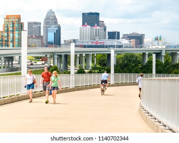 LOUISVILLE, KENTUCKY:  JULY 3, 2018 - People Travel To Walk And Bike On Public Space By The Big Four Bridge Shared Urban Path In Downtown Park Of Louisville, Kentucky