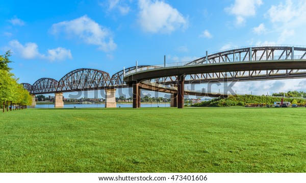 LOUISVILLE,\
KENTUCKY, USA - AUG. 21: The Big Four pedestrian bridge spans the\
Ohio River from Louisville KY to Jeffersonville, IN. The bridge\
welcomes walkers, joggers and\
bicyclists.