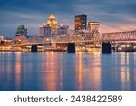 Louisville, Kentucky, USA. Cityscape image of Louisville, Kentucky, USA downtown skyline with reflection of the city the Ohio River at spring sunset.