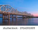 Louisville, Kentucky, USA with John F. Kennedy Memorial Bridge spanning the Ohio River at dusk.