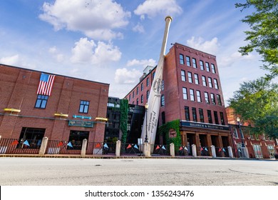 LOUISVILLE, KY, USA - JULY 23, 2018: The Louisville Slugger Museum & Factory with a dramatic blue sky and clouds in the background.