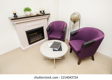 Lounge Area With Two Chairs, Cofee Table And Fireplace