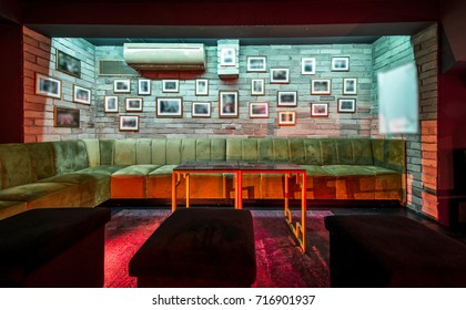 Lounge bar with sofas and decorative brick wall