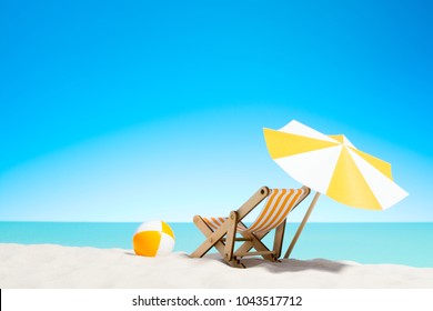 Lounge Chair With Parasol And Beach Ball On The Coast, Sky With Copy Space