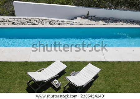 Lounge chairs by modern lap pool