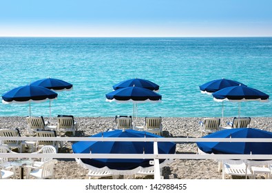 Lounge Chairs And Parasol On The Beach, Southern France
