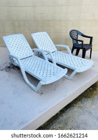 Lounge Chairs At Poolside After Rain Storm / Slippery Walkway At Pool 