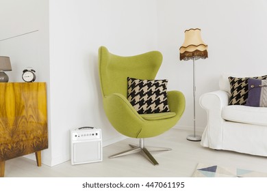 Lounge corner of a modern apartment with a cosy swivel egg chair