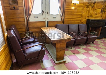 Lounge on the ship. Chairs and a table for playing chess.