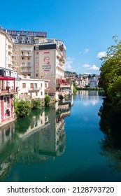 Lourdes, France - August 28, 2021: Cityscape of Lourdes with hotels and residential buildings on the banks of the river Ousse