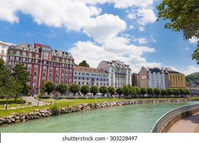 LOURDES, FRANCE - JULY 23, 2014: Hotels in Lourdes situated along the river Gave de Pau. Lourdes is famous for the Marian spirit of Our Lady of Lourdes to have occurred in 1858 to Bernadette Soubirous