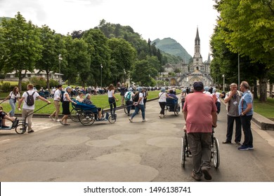 Lourdes, France June 24, 2019: Volunteers helping the sick get to the sanctuary of Our Lady in Lourdes, famous for many healings.