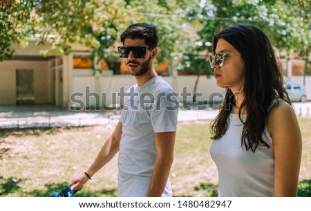 Similar – Smiling young woman looking at camera over sunglasses