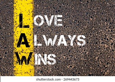 Love Always Wins - LAW Concept. Conceptual image with yellow paint line on the road over asphalt stone background.