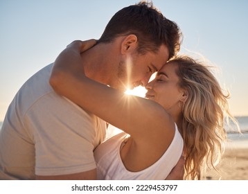 Love, beach hug and couple face together on sunset vacation date by the sea for romance, affection and relationship commitment. Happy man, woman with a smile and romantic ocean summer holiday getaway - Powered by Shutterstock