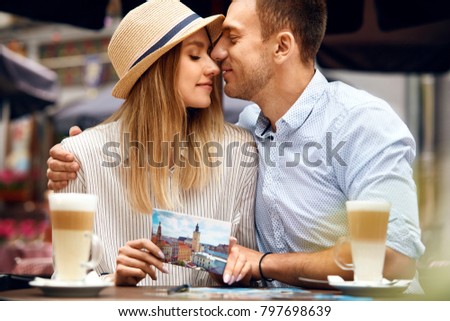 Love. Beautiful Couple Sitting In Cafe. Man And Woman Spending Time Together, Sitting At Table With Postcards And Fresh Coffee Drink On Romantic Date. Relationship Concept. High Quality Image