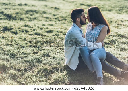 Love beautiful couple walking in a green park, spring, sun