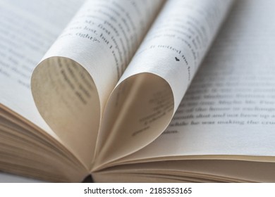 Love of books, reading. An open book with folded pages of books in the shape of a heart. Knowledge Day, Teacher's Day. Library. Reading books. - Shutterstock ID 2185353165