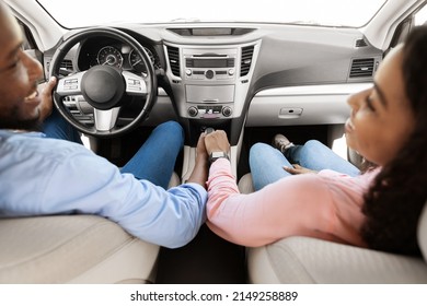 Love And Care. Above Top High Angle View Of Cheerful Black Couple Holding Hands While Sitting In Comfortable Auto. African American Guy Having Car Trip With His Girlfriend, Summer Vacation Concept