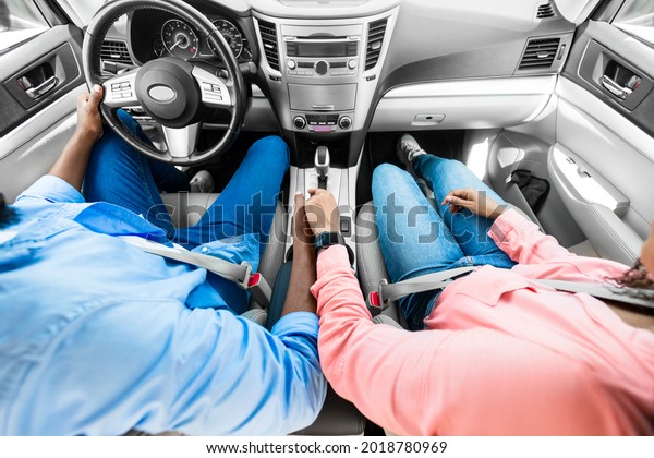 Love And Care.\
Above top high angle view of black couple holding hands while\
sitting in comfortable auto. African American guy having car trip\
with his girlfriend, vacation\
concept